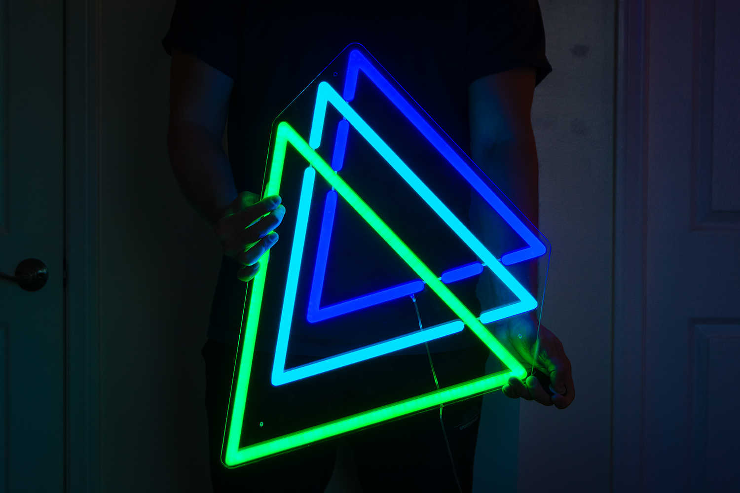 A three color neon sign of three triangles