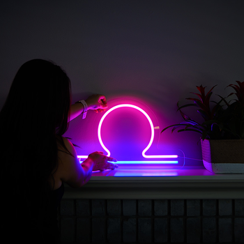 A girl holding a libra zodiac neon sign by Valoneon