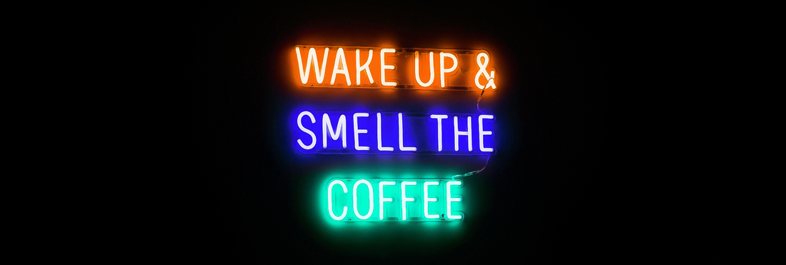 a neon sign that says wake up & smell the coffee