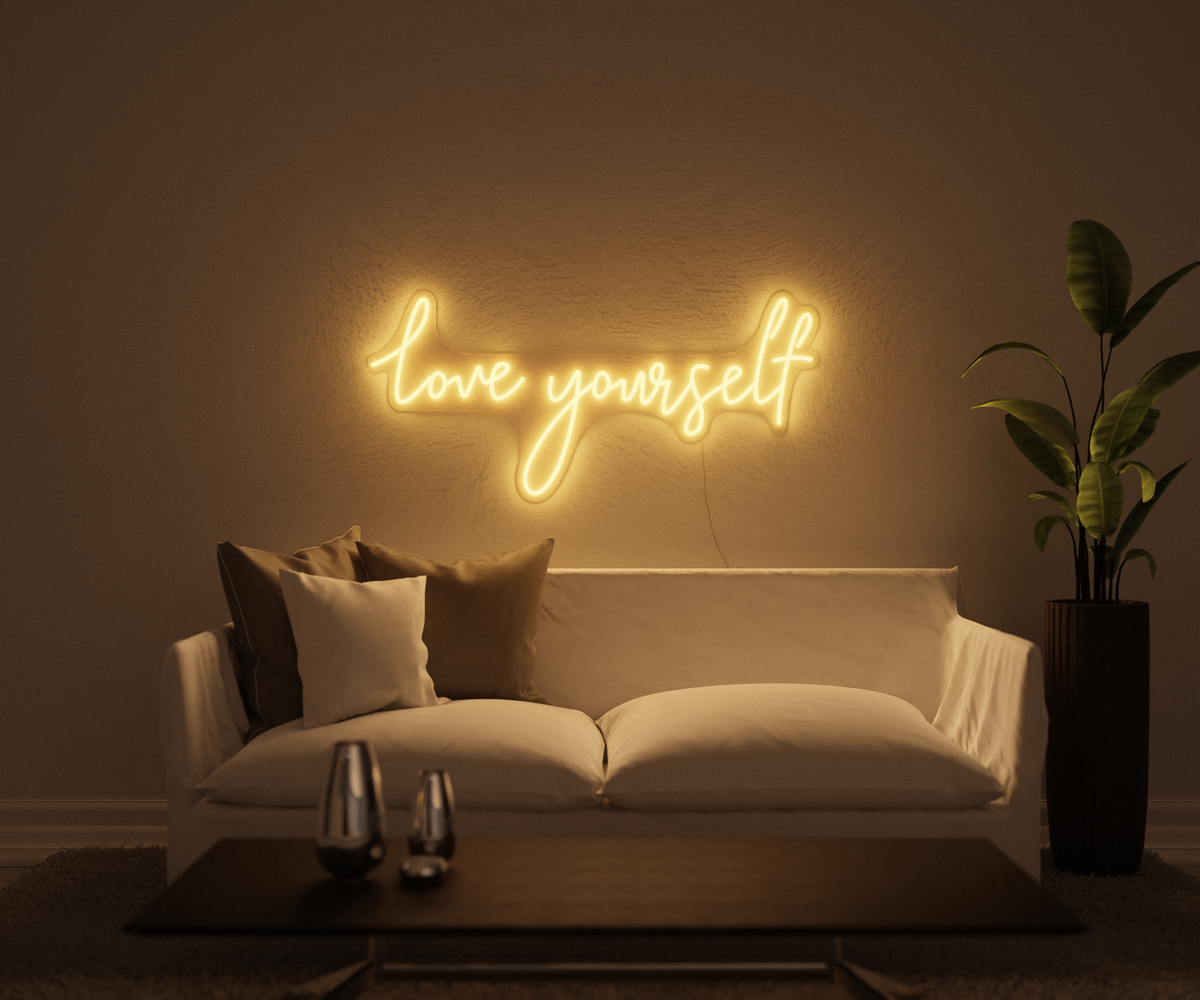 A modern interior with the lights off and a neon sign on the wall