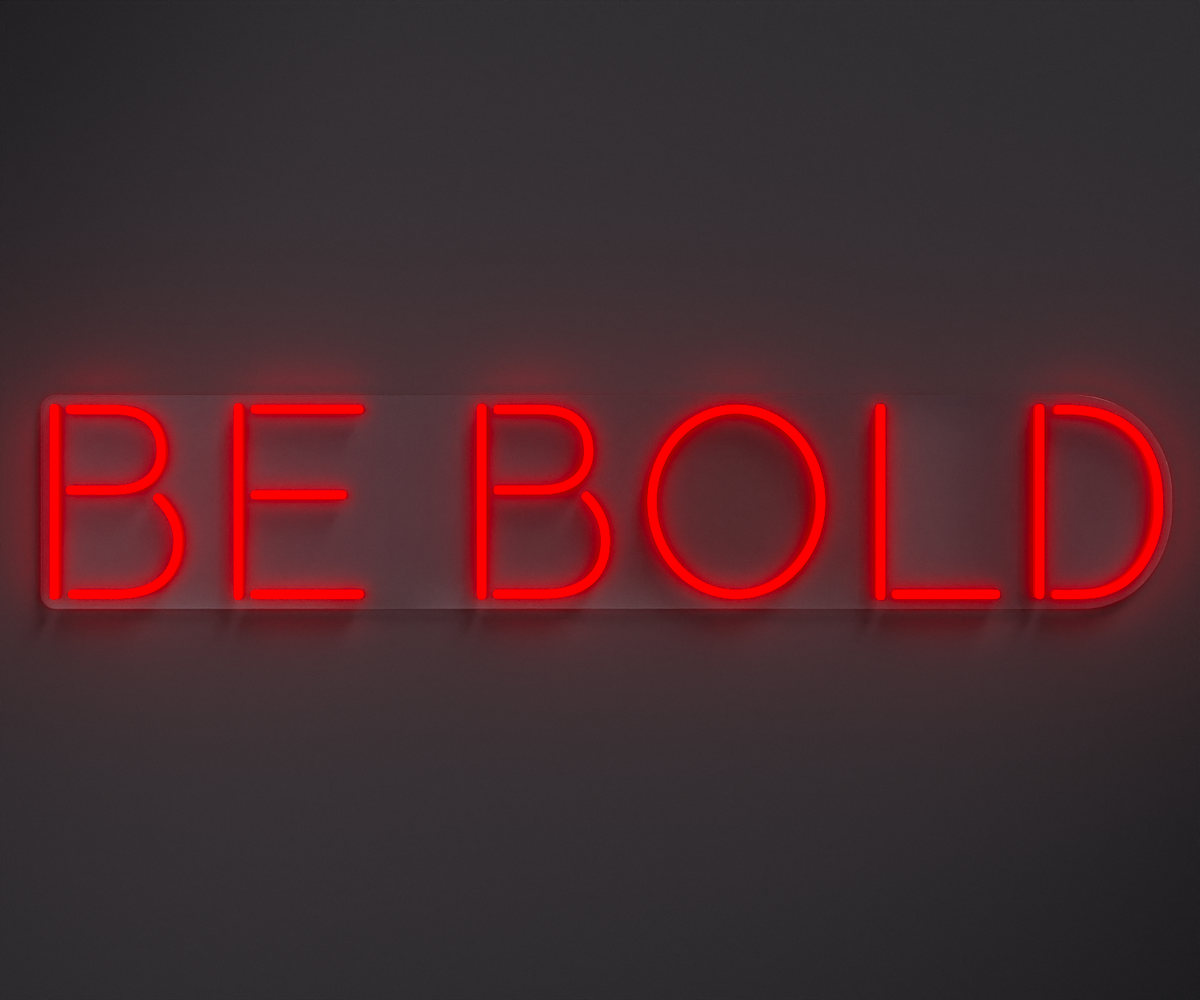 red neon sign that says be bold