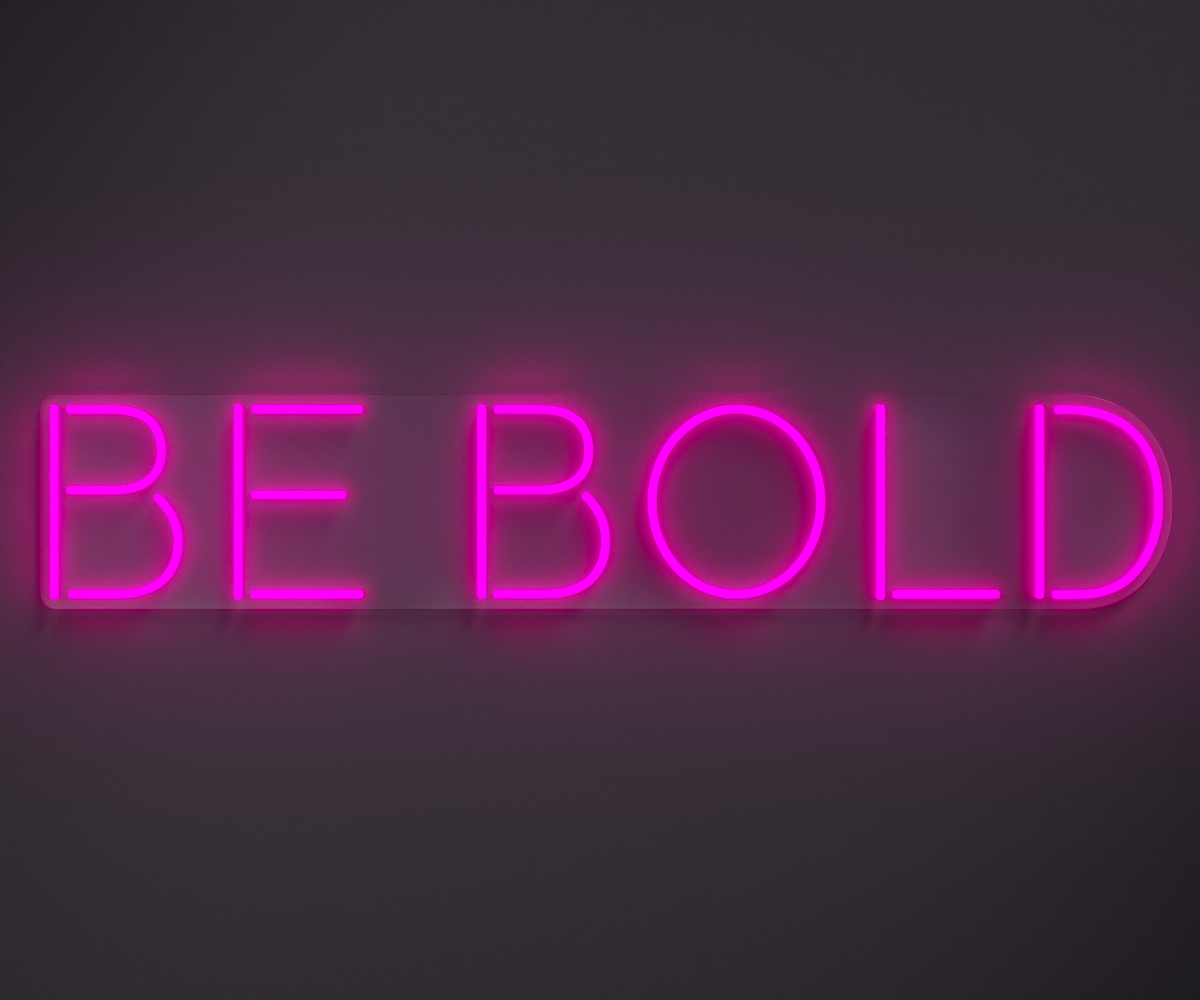light pink neon sign that says be bold