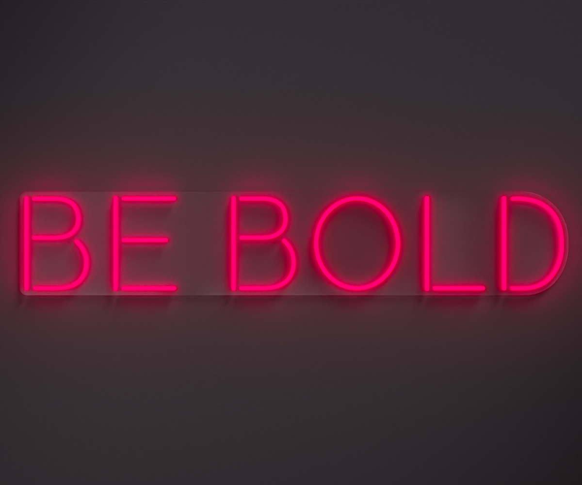 pink neon sign that says be bold