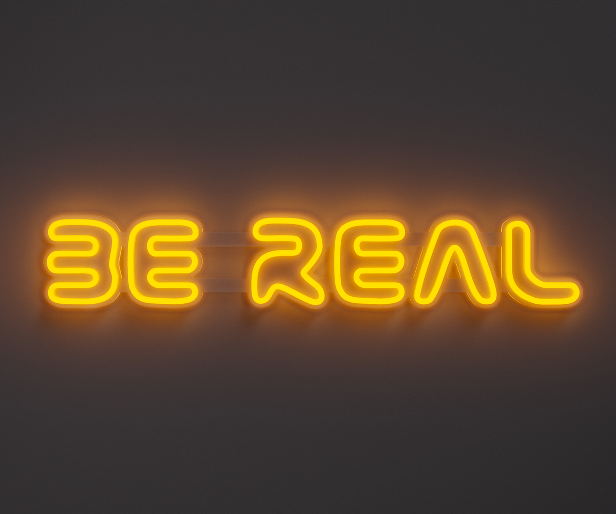 yellow neon sign that says be real