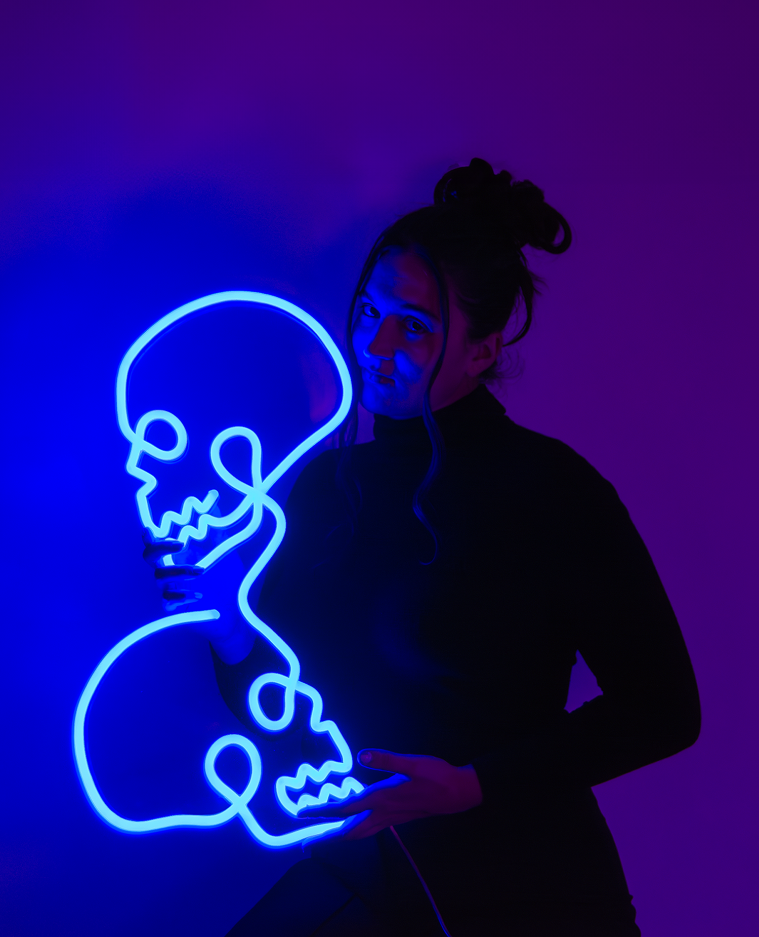 Girl holding a blue neon sign