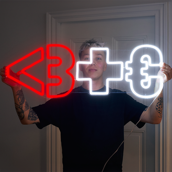 A man showing off his custom neon sign