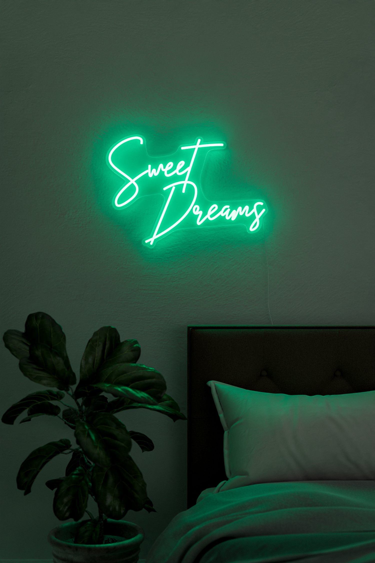 a green 'sweet dreams' neon sign in bedroom