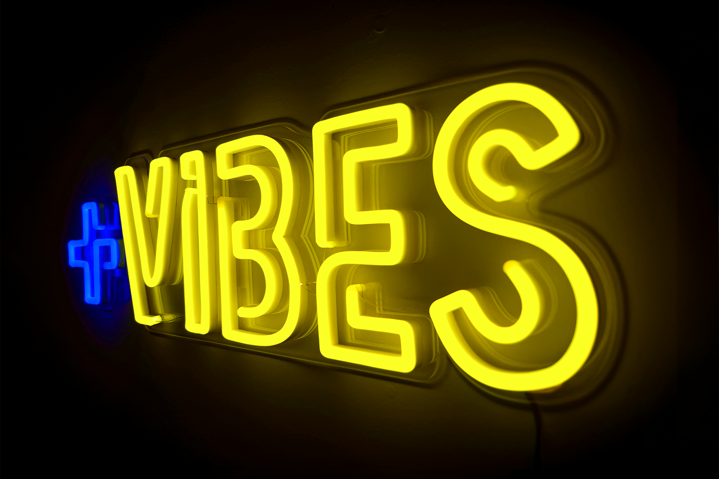 A blue and yellow neon sign that says positive vibes.